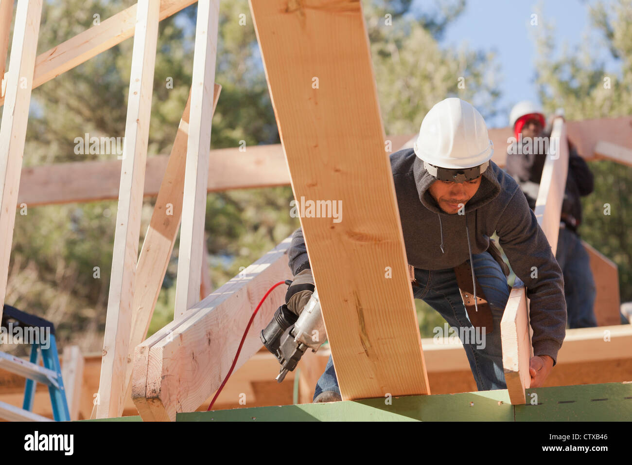 Carpenters placing roof rafter Stock Photo - Alamy