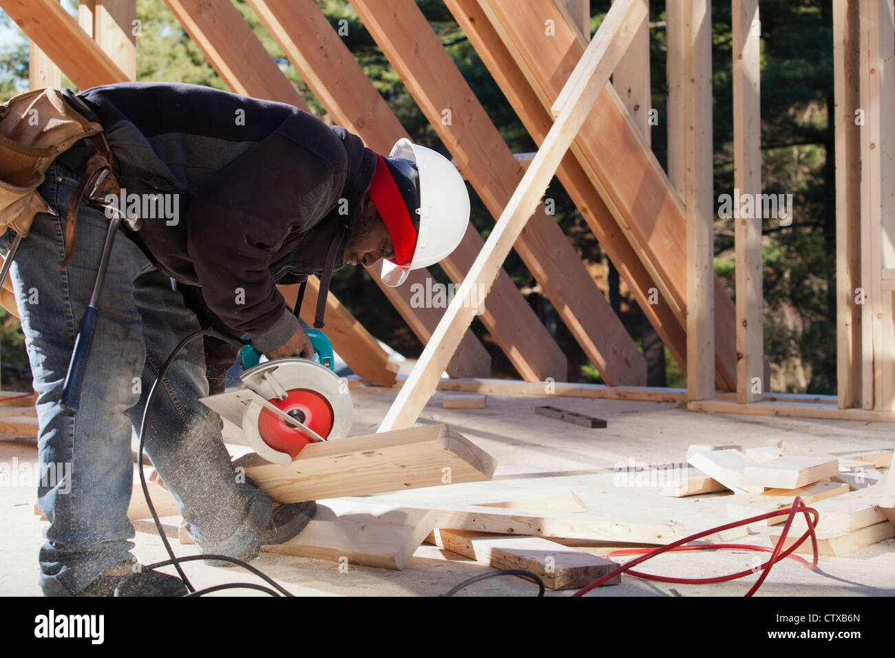Carpenter cutting bevel on rafter with a circular saw Stock Photo Alamy