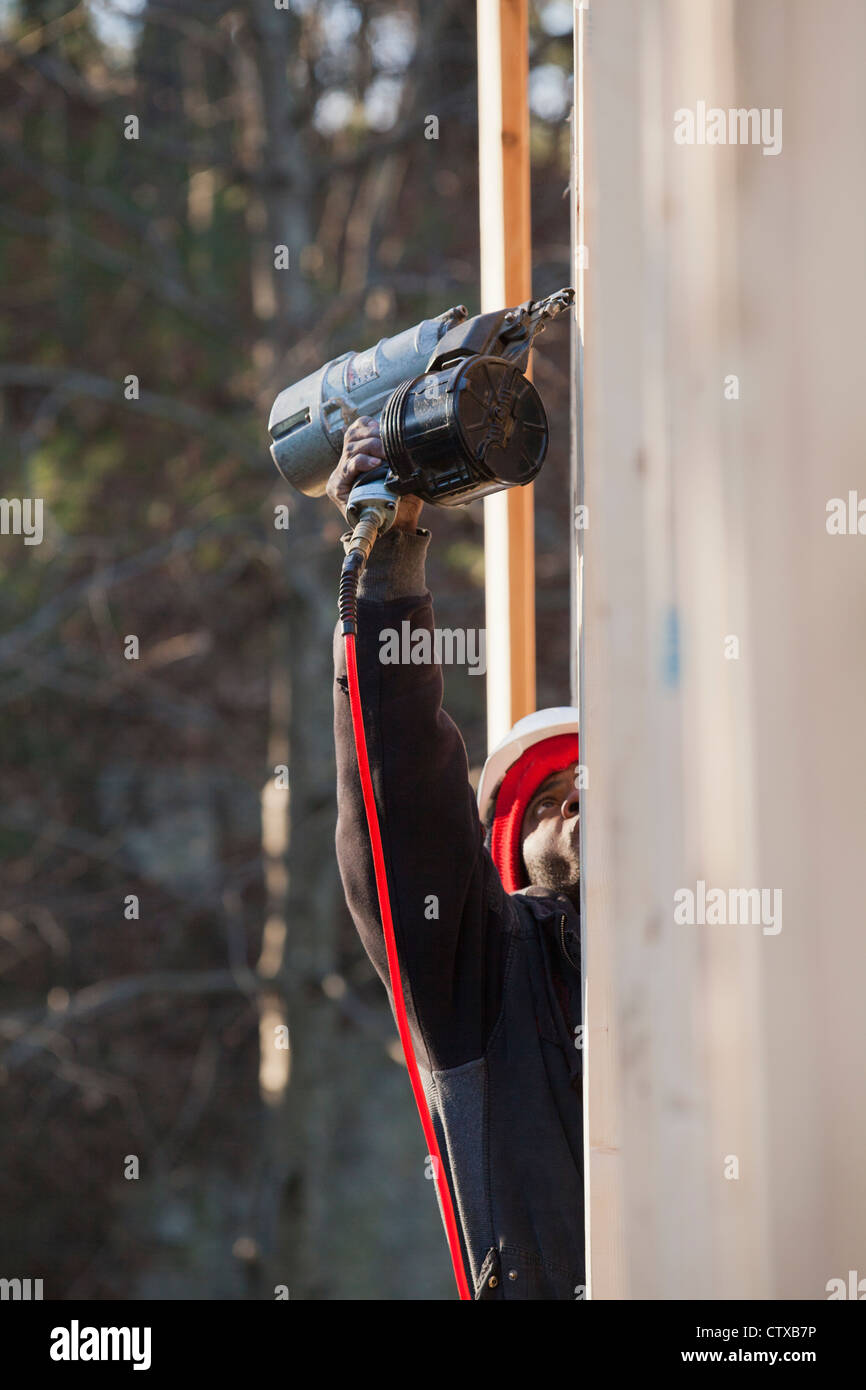 Carpenter using a nail gun on framing Stock Photo Alamy