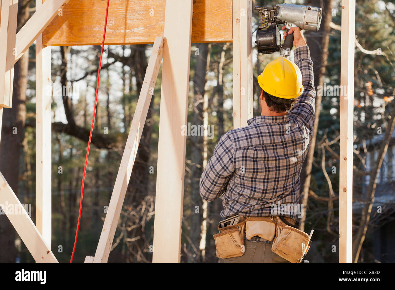 Carpenter using a nail gun for framing Stock Photo Alamy