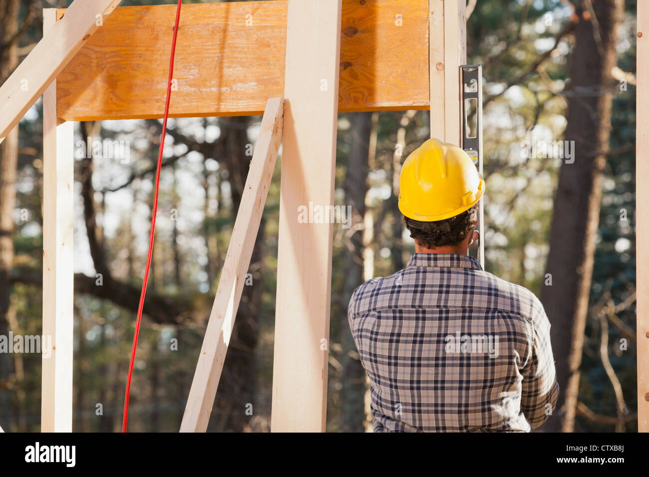 Carpenter using a level on framing Stock Photo Alamy