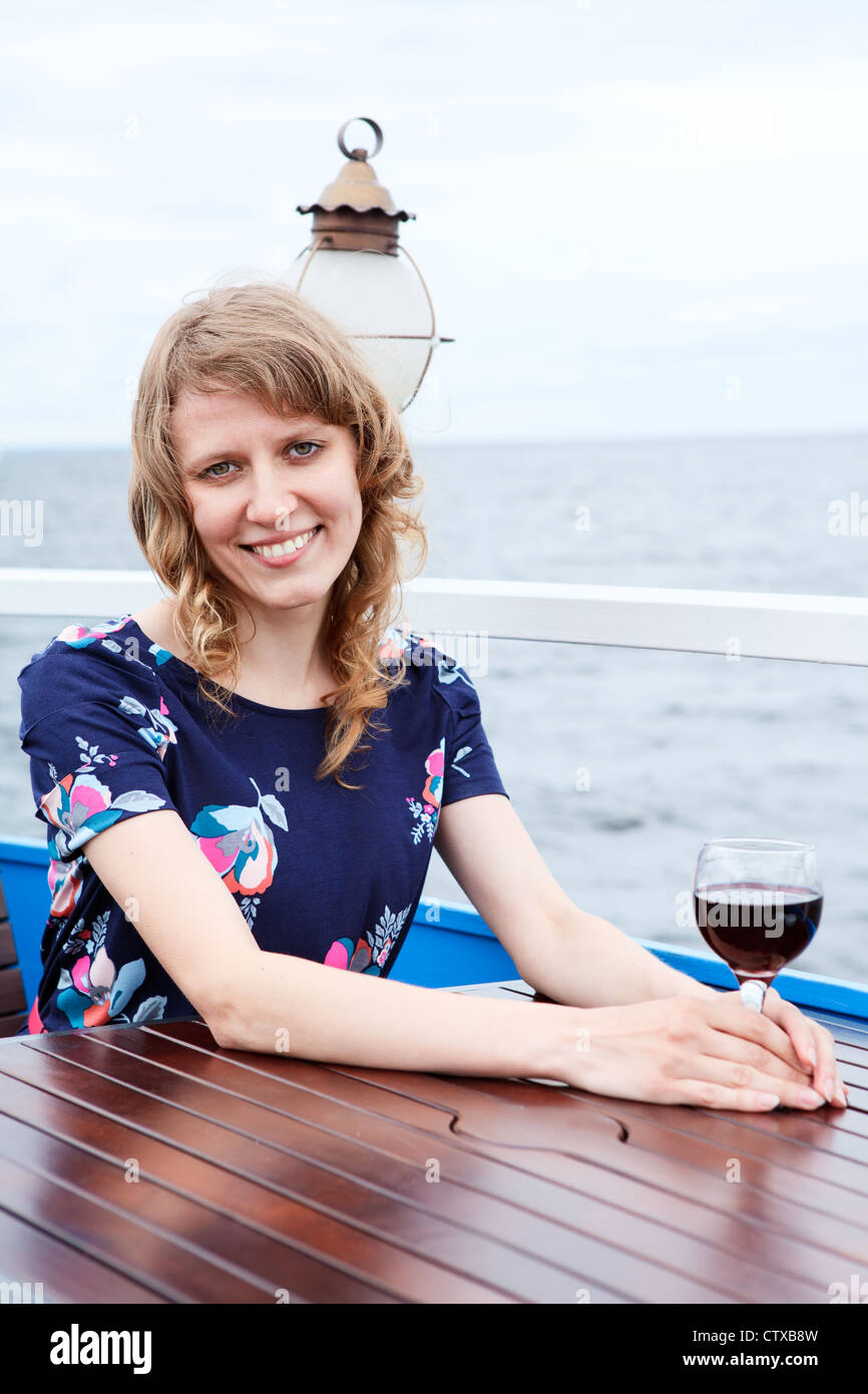 Woman in dress with red wine glass at the table Stock Photo Alamy