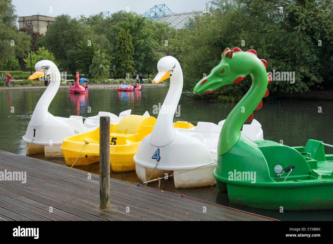 Swan and dragon shaped pedalos or pedal boats, Alexandra Palace Park boating lake, Haringey, London England UK Stock Photo