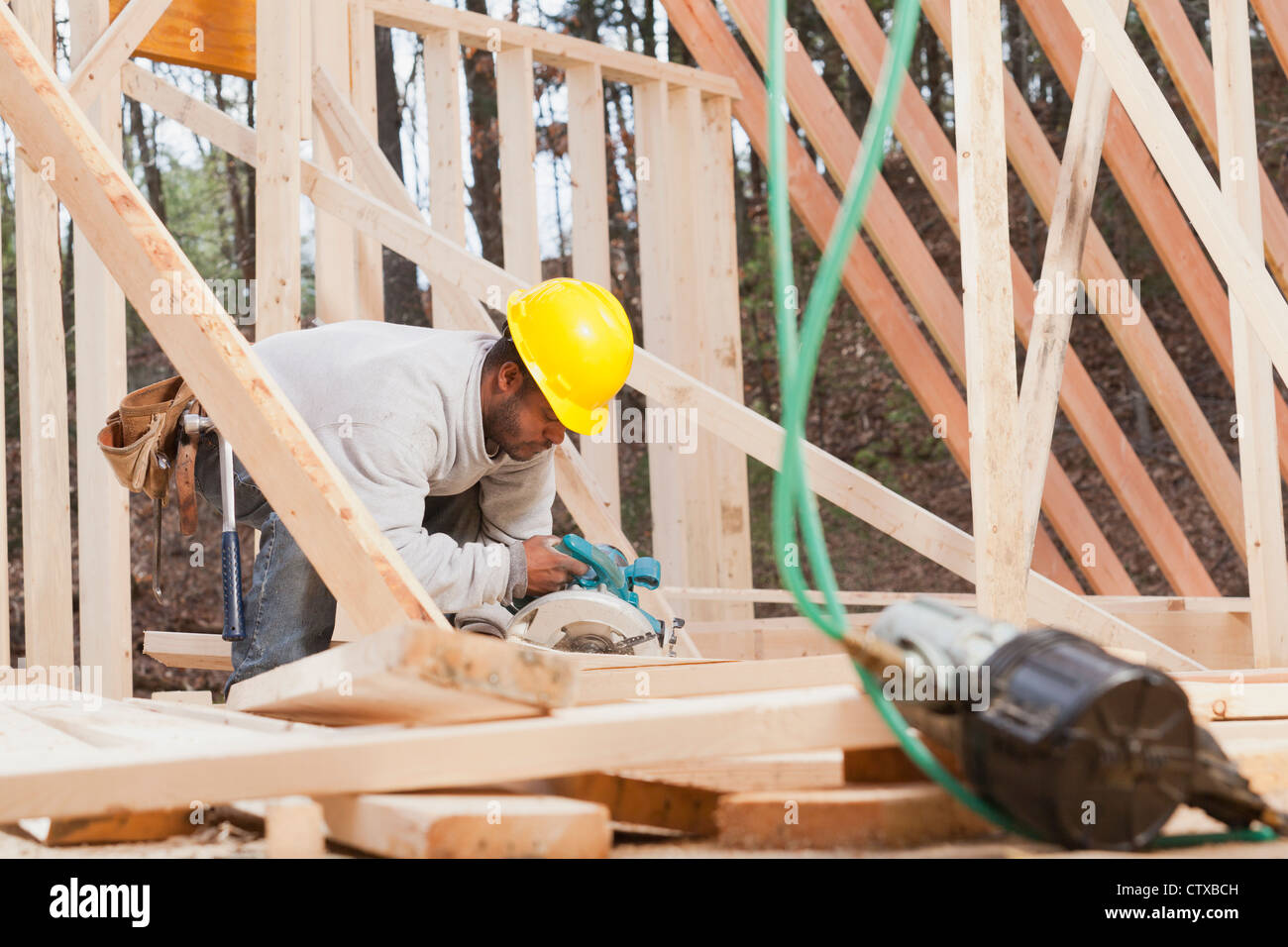 Carpenter making bevel cut using a circular saw Stock Photo Alamy