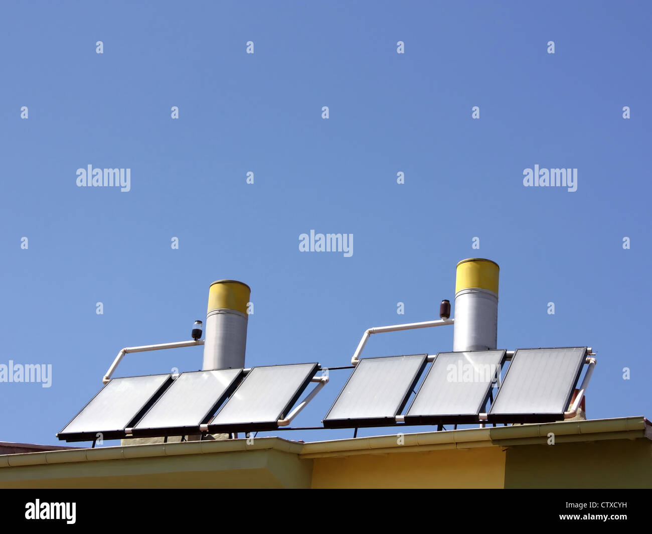 Solar water heating panels on a house roof Stock Photo