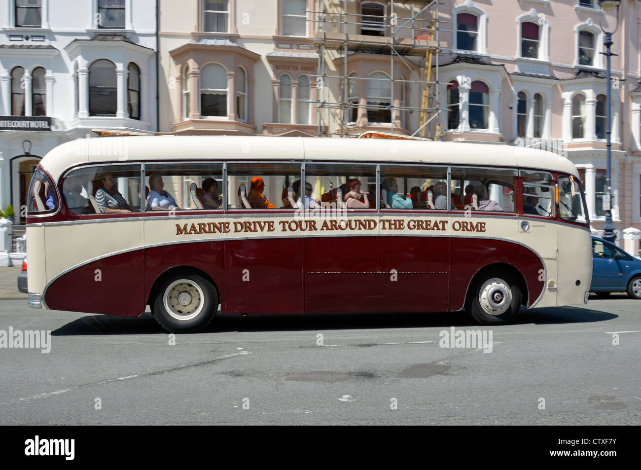 Old fashioned coach being used for scenic tour around the Great Orme Marine Drive Stock Photo