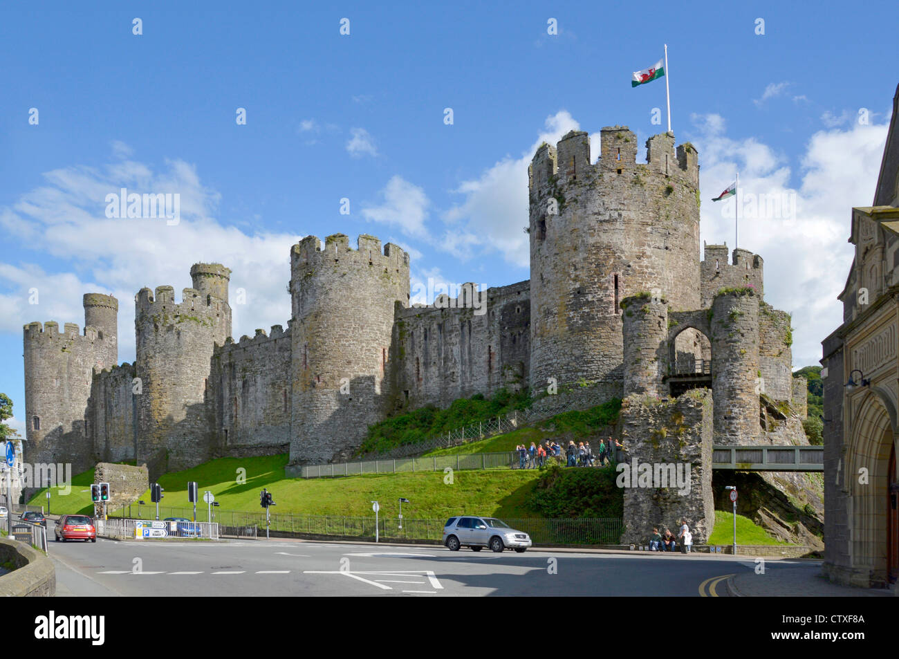 Wales dragon flag over ruins of massive defensive walls of Medieval Conwy Castle in Conway town  in Conwy County Borough Clwyd North Wales UK Stock Photo