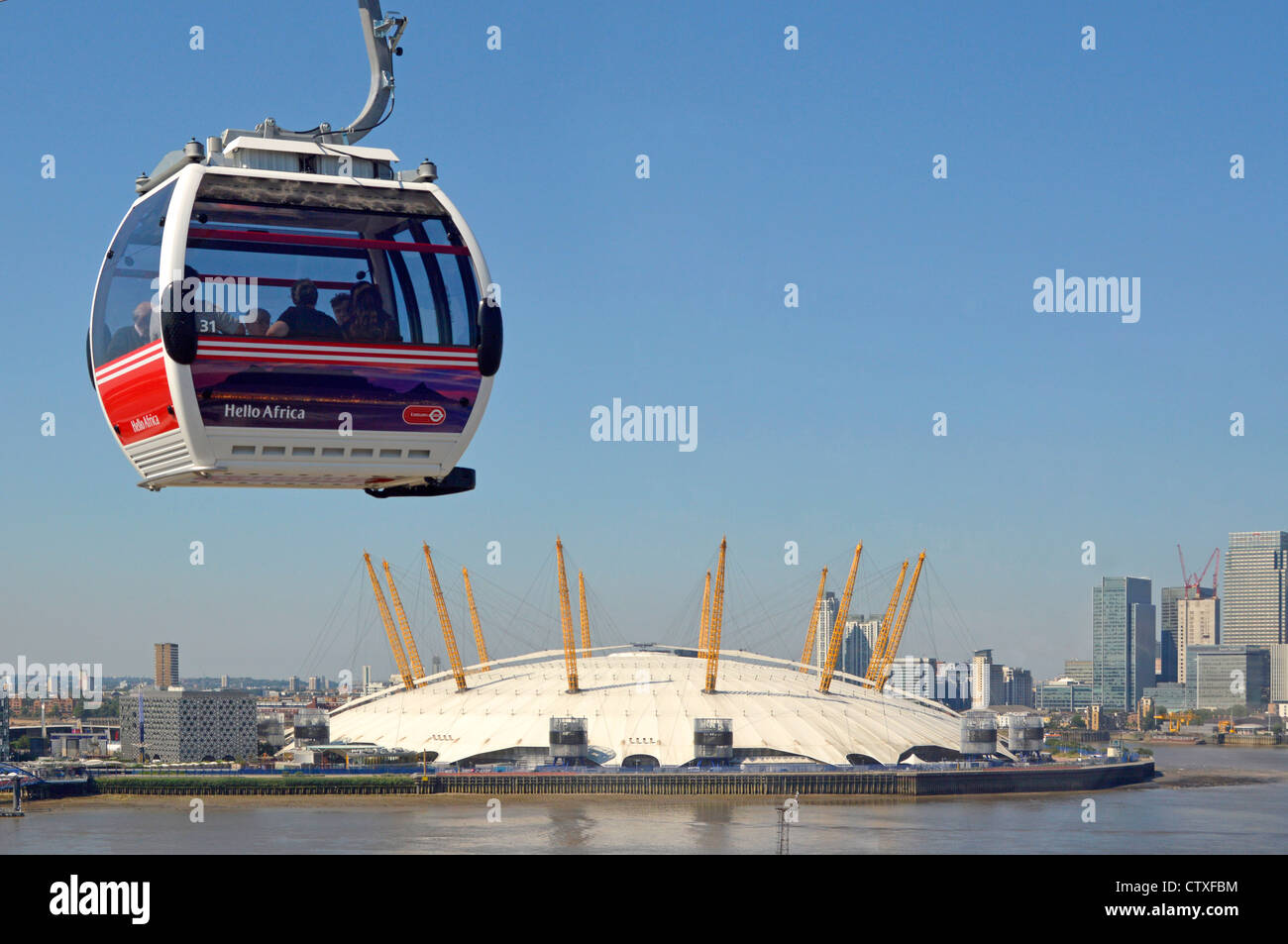 View of The 02 o2 arena dome from inside Emirates Air Line sponsored cable car cabin crossing River Thames with passing cabin Stock Photo