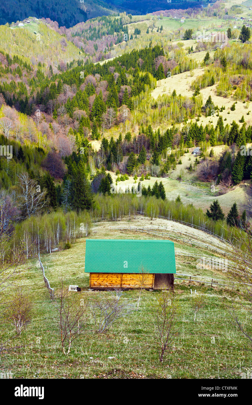 Landscape with a wooden house and mountains in the background Stock ...