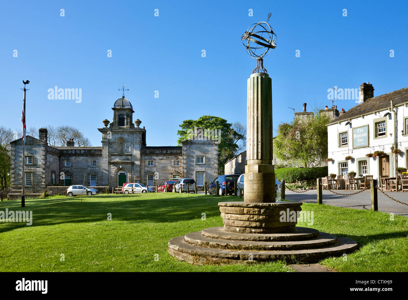 Linton village, Yorkshire Dales. Showing the Almshouses, sun dial and