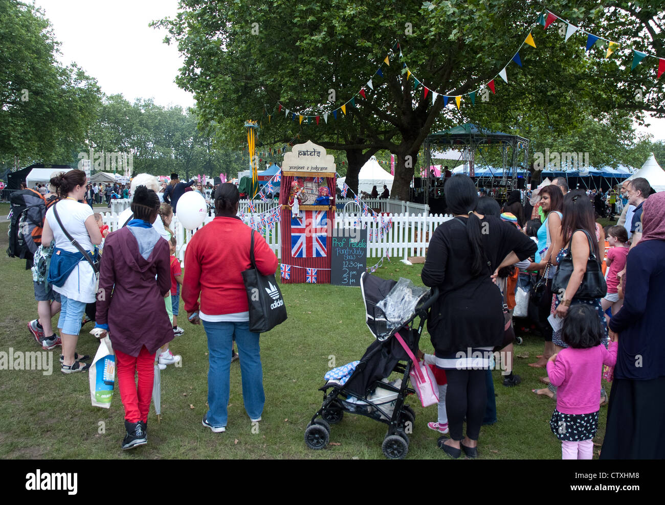 crowds arrive to watch the show performed by  Aftab Khan aka Prof Patel  Britain's first Asian Punch & Judy Professor Stock Photo