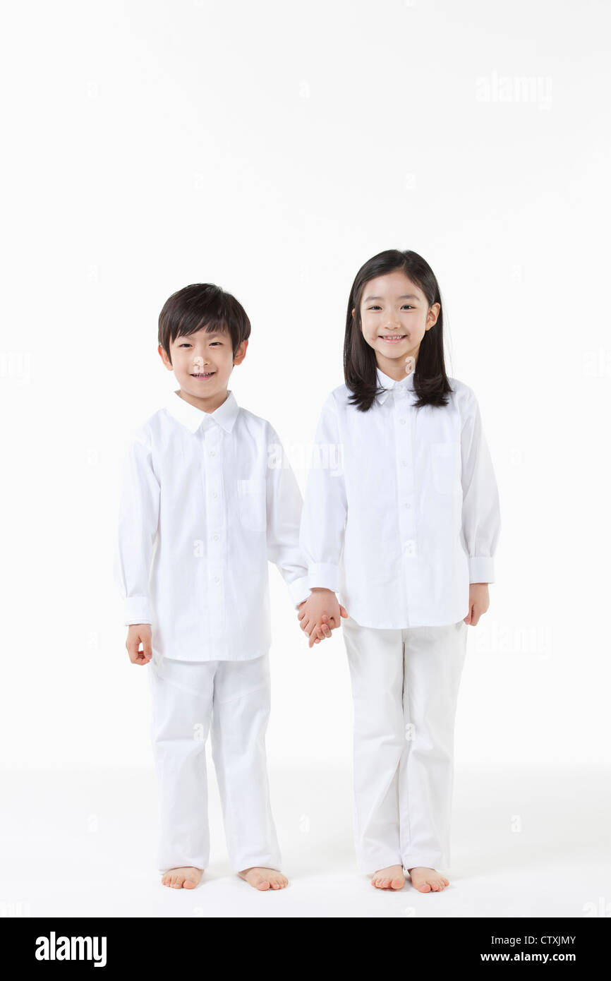 A boy and girl holding hands together Stock Photo - Alamy
