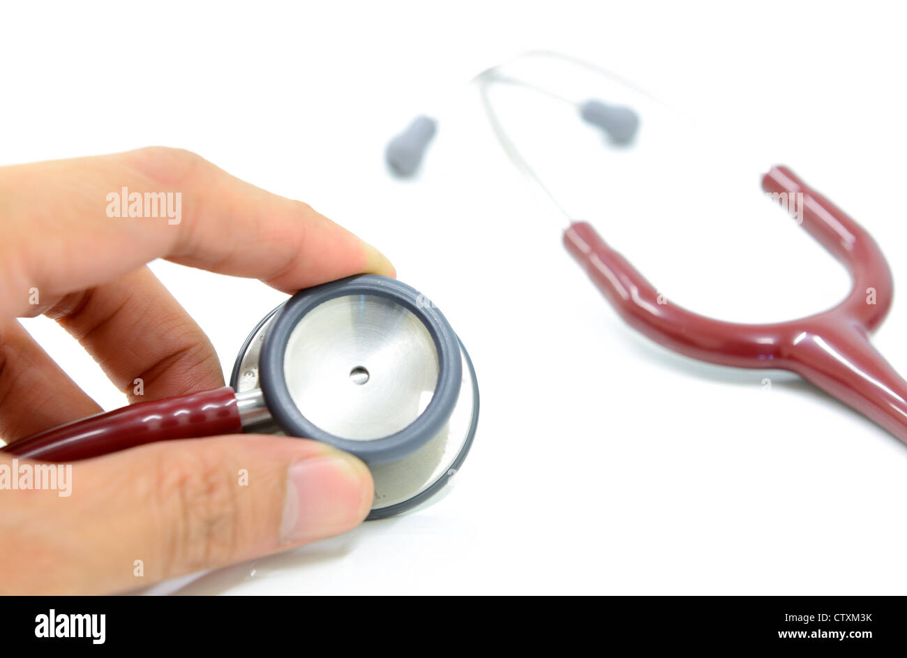 The doctor hand is holding stethoscope, isolated on the white background. Stock Photo