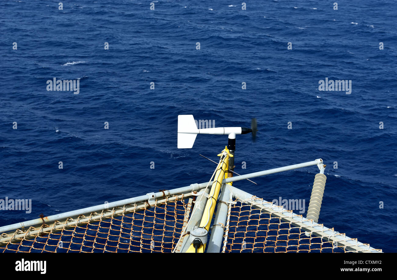 The wind velocity and direction indicator is set on the corner of oil rig helideck . Stock Photo