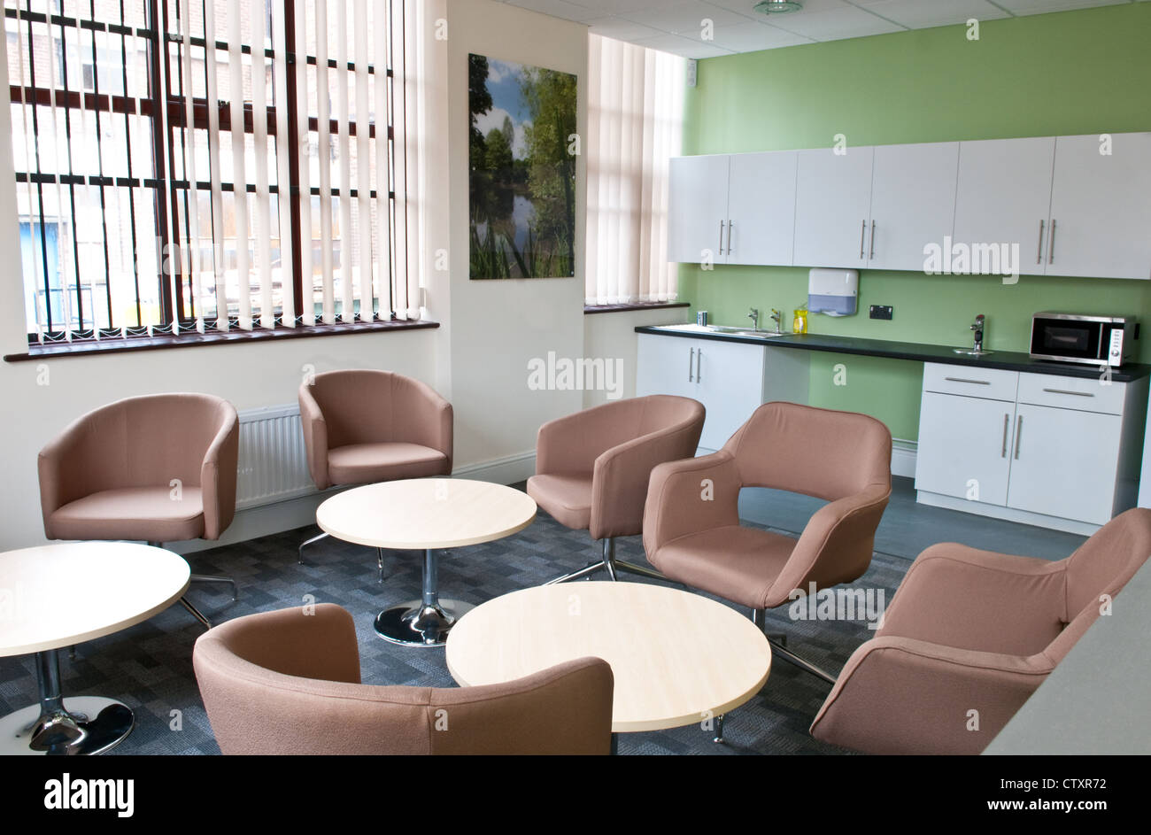 Breakout communal kitchen area with chairs and tables in a modern open