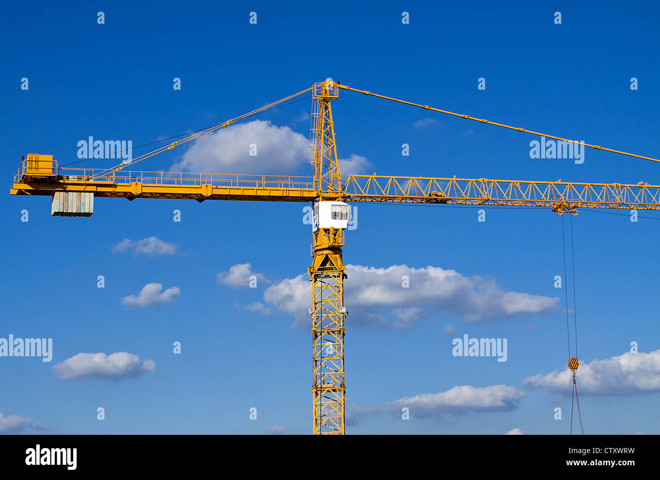 Construction crane against a blue sky with cloud background Stock Photo ...