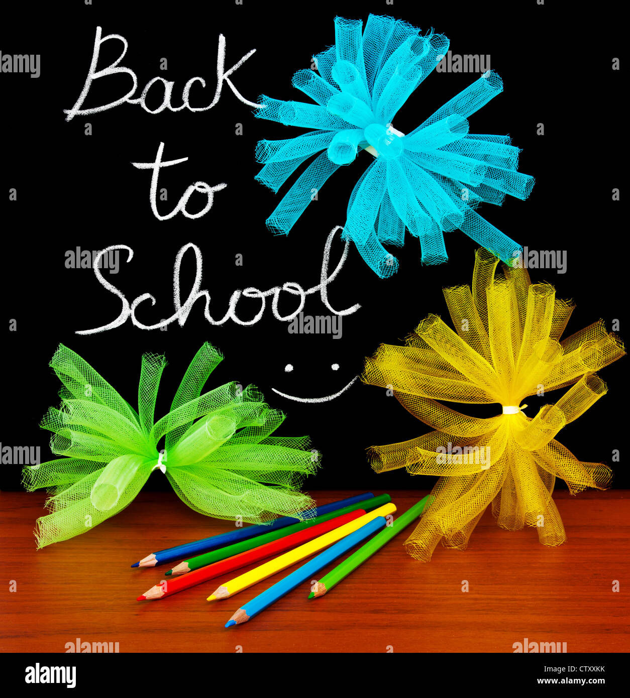 Back to school concept, handwriting on a black chalkboard with colorful objects Stock Photo