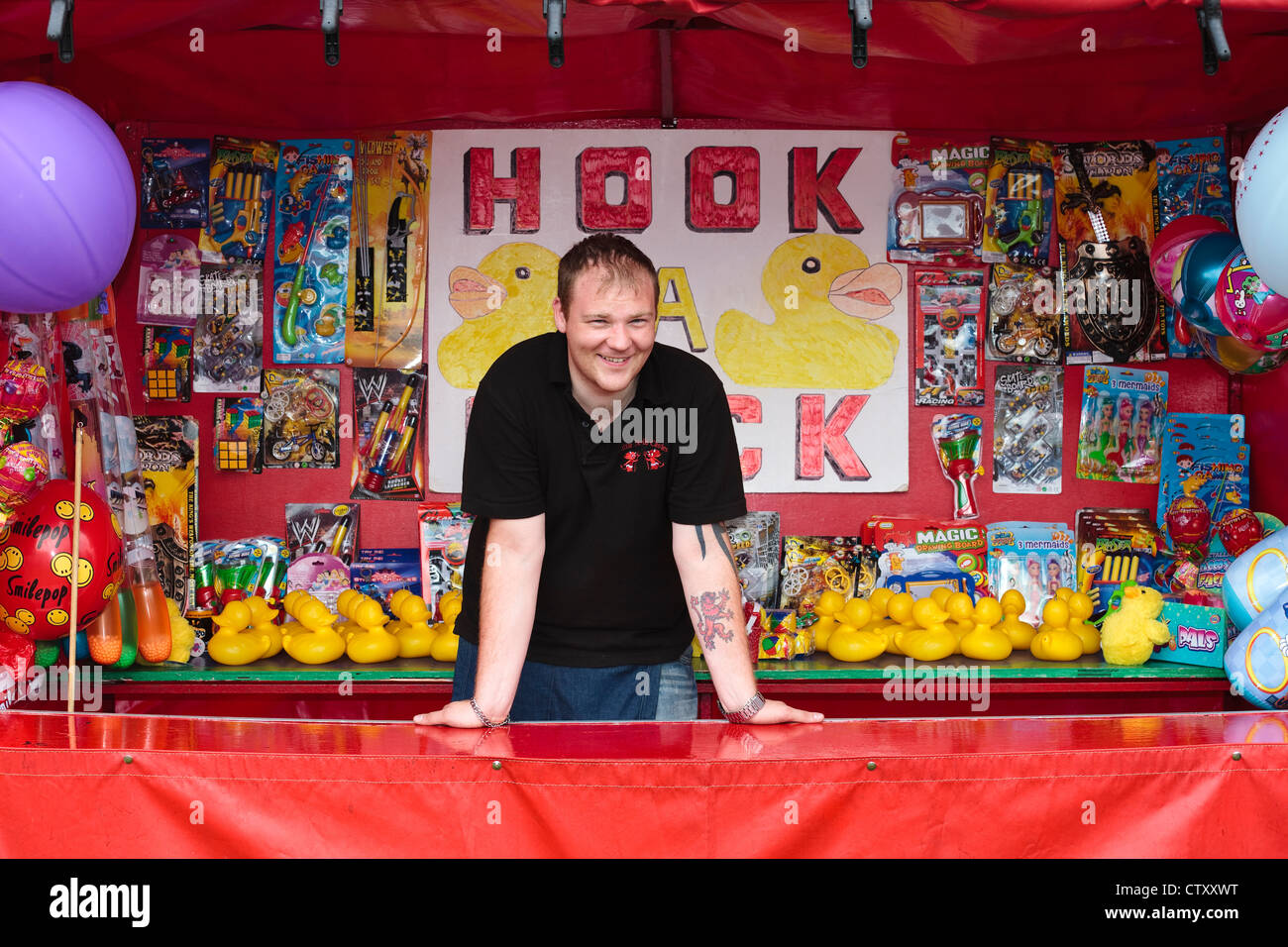 John Mitchell running a 'duck' stall at a fairground, Dundonald, Ayrshire, Scotland, UK Stock Photo