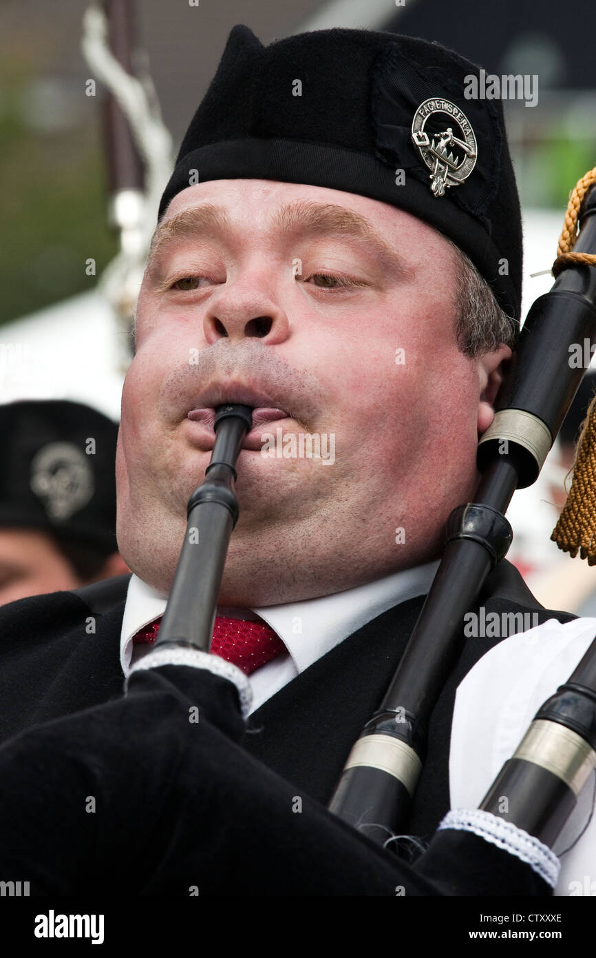 Adult man playing the bagpipes, Dundonald Highland Games, Ayrshire, Scotland, UK Stock Photo