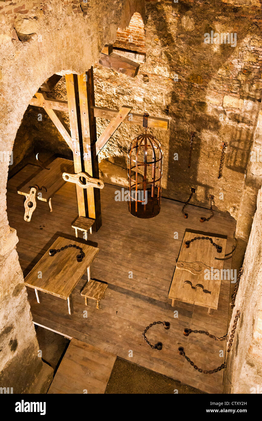 Holding cell in a medieval prison, with torture instruments Stock Photo