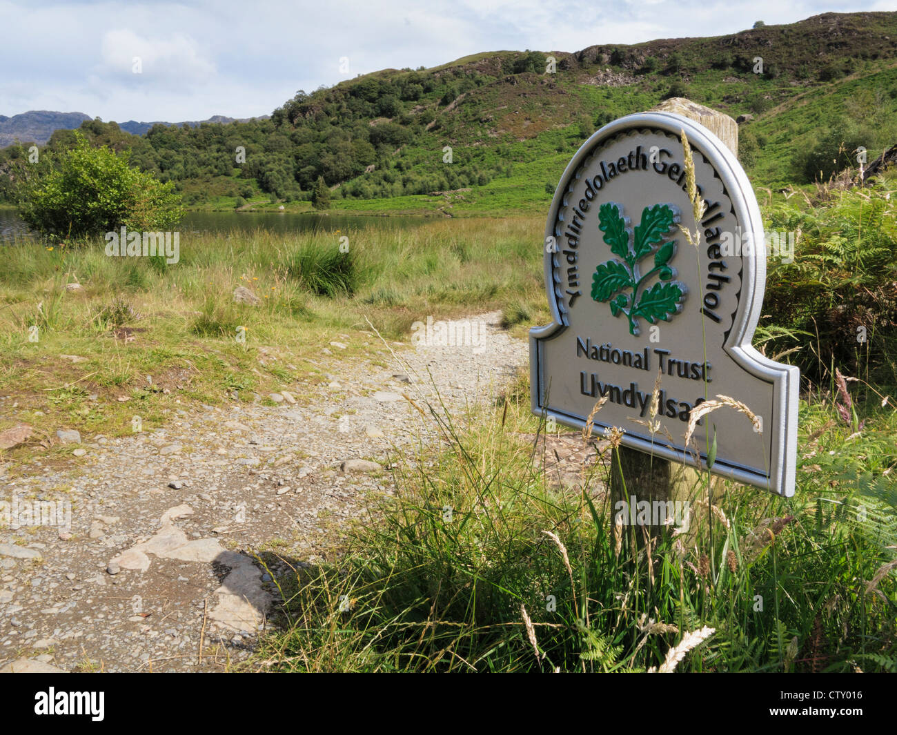 National Trust sign for Llyndy Isaf farm by path around Llyn Dinas lake in Snowdonia. Nantgwynant, North Wales, UK, Britain Stock Photo