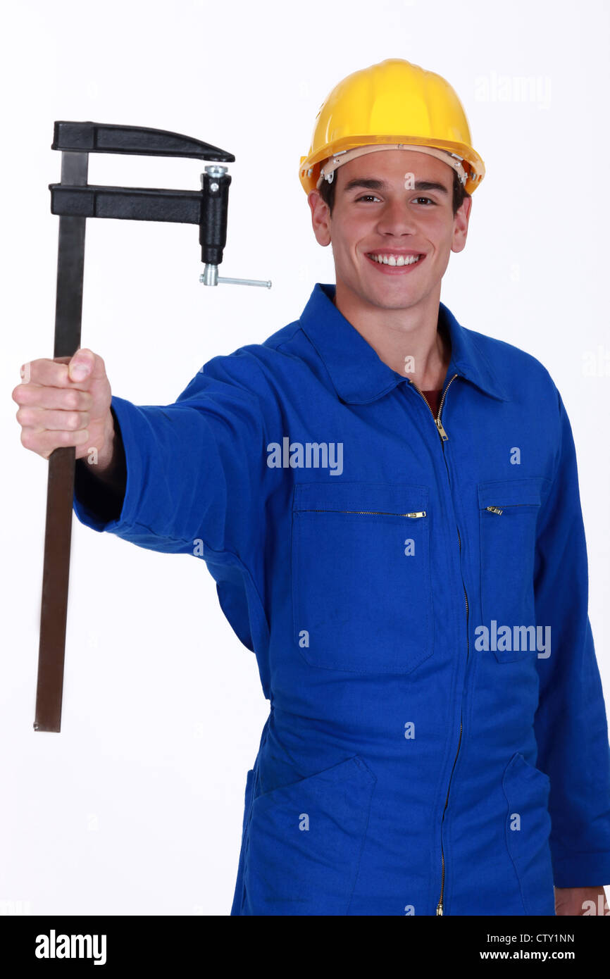 Young construction worker with an F clamp Stock Photo