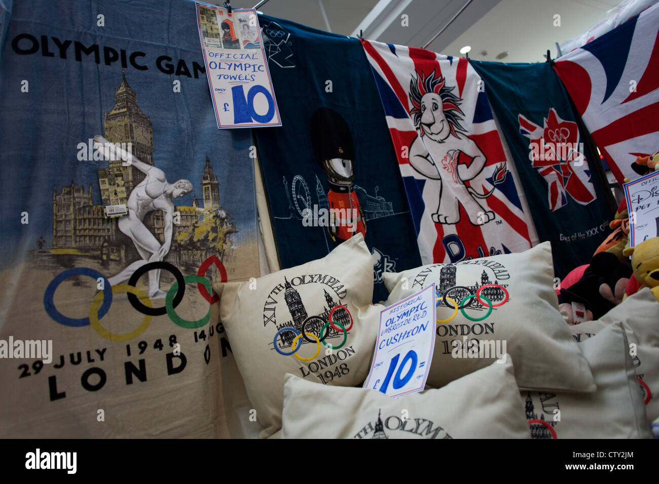 In the local community Stratford Centre shopping mall in East London, we see official Olympic merchandising on sale during the London 2012 Olympics, the 30th Olympiad. A few hundred metres from the giant Westfield plaza complex that acts as a gateway to the main Olympic arenas, this market outdates the newer development where similar souvenirs can be bought for up to twice the prices offered by the stall holder. Cashions are £10 (Pounds) and duvet covers (bedding) are £20. Stock Photo
