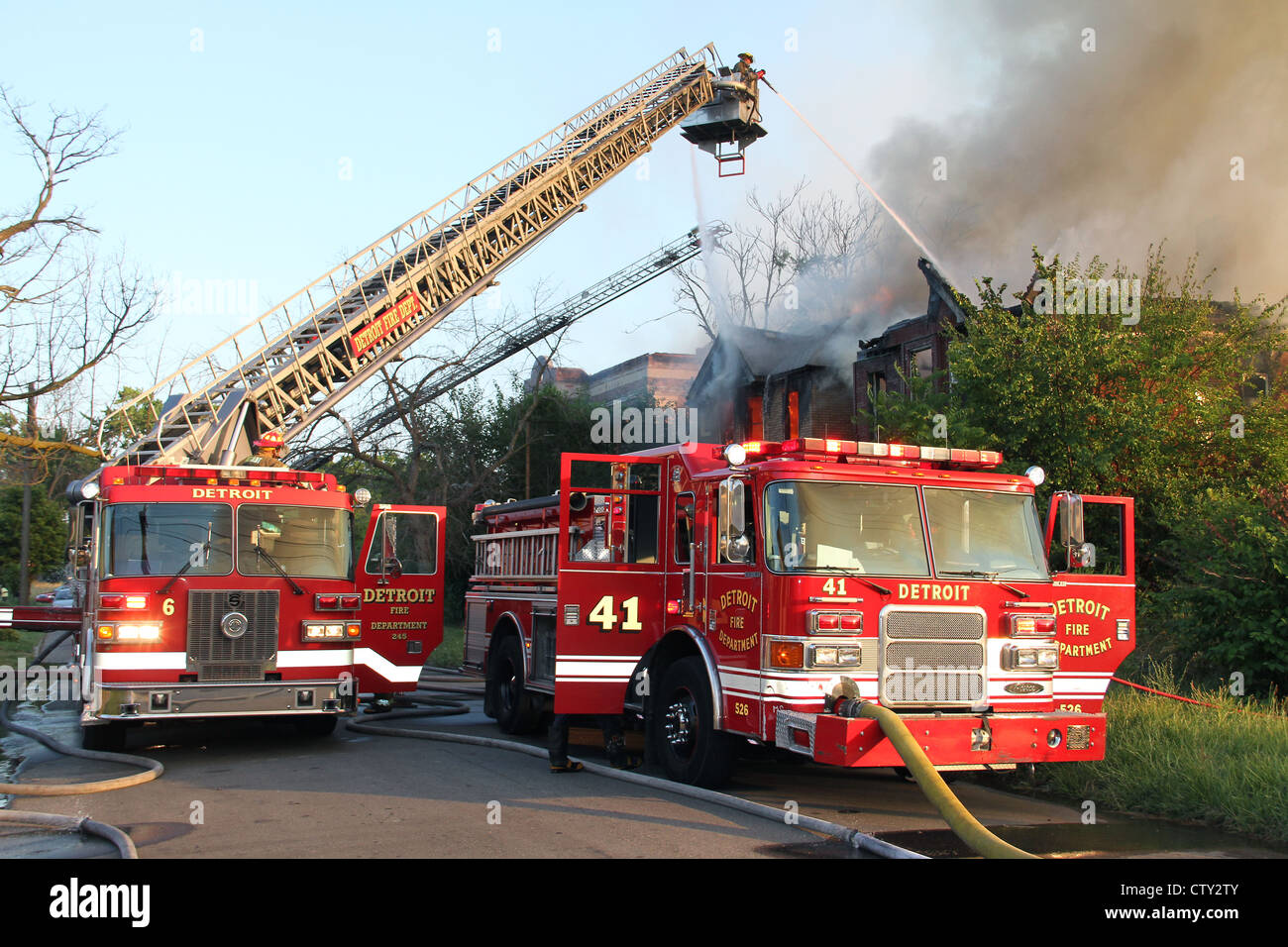 Detroit Fire Department Aerial Platforms & Fire Engines extinguishing fire in two vacant Two-flat apartment buildings Detroit MI Stock Photo