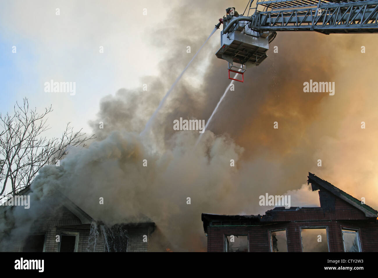 Detroit Fire Department Aerial Platform extinguishing two apartment building fires, Detroit Michigan USA Stock Photo