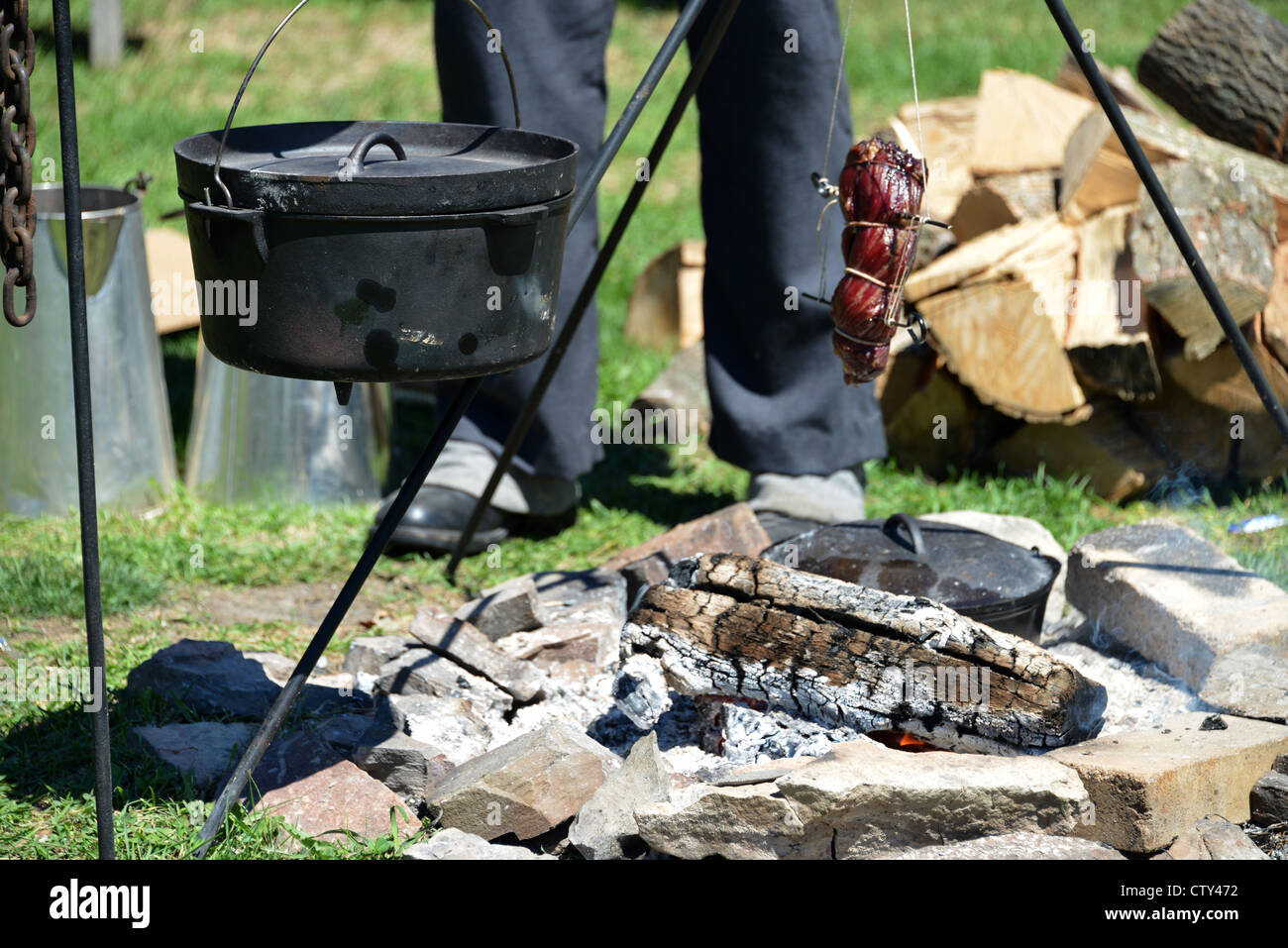 This is an image of a man cooking with traditional cookware from the War of 1812 at Fort York national historical site, Toronto. Stock Photo