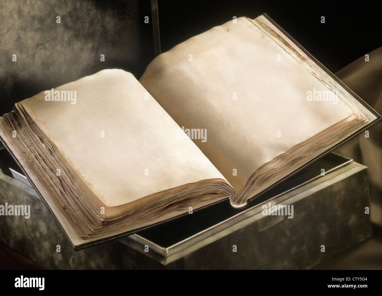 Old book open laying on a box with two blank pages. Real ancient texture Stock Photo