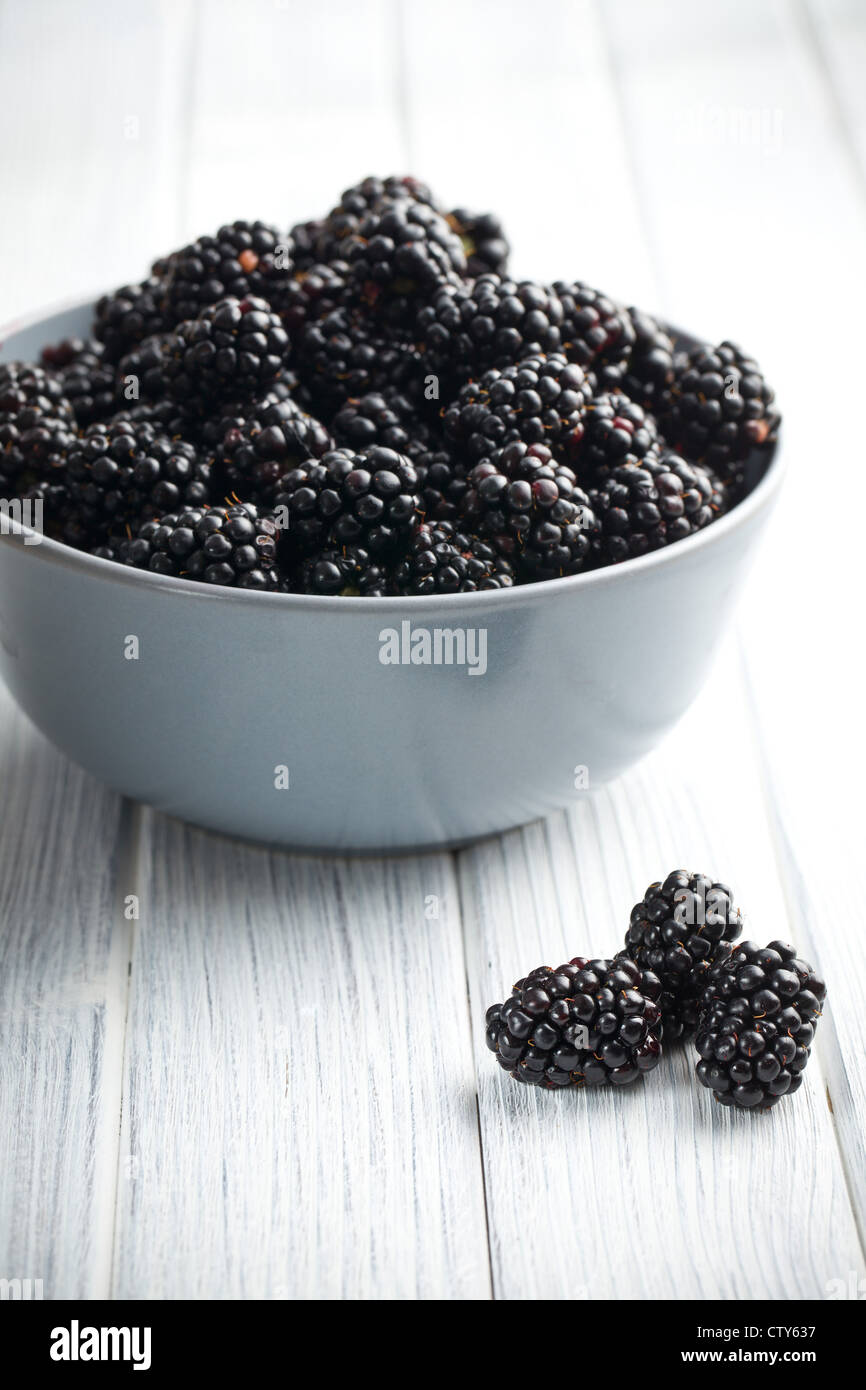 blackberry fruit in bowl on kitchen table Stock Photo