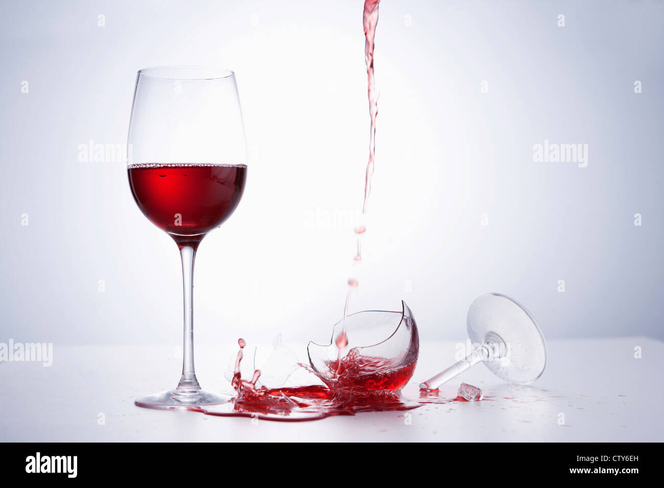 A glass of wine and dropping wine onto a broken glass Stock Photo Alamy
