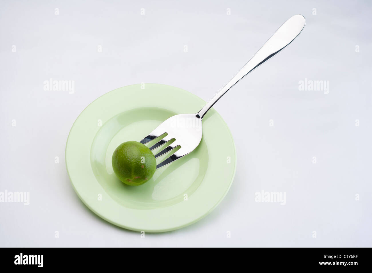 Speared lime with the fork Stock Photo Alamy