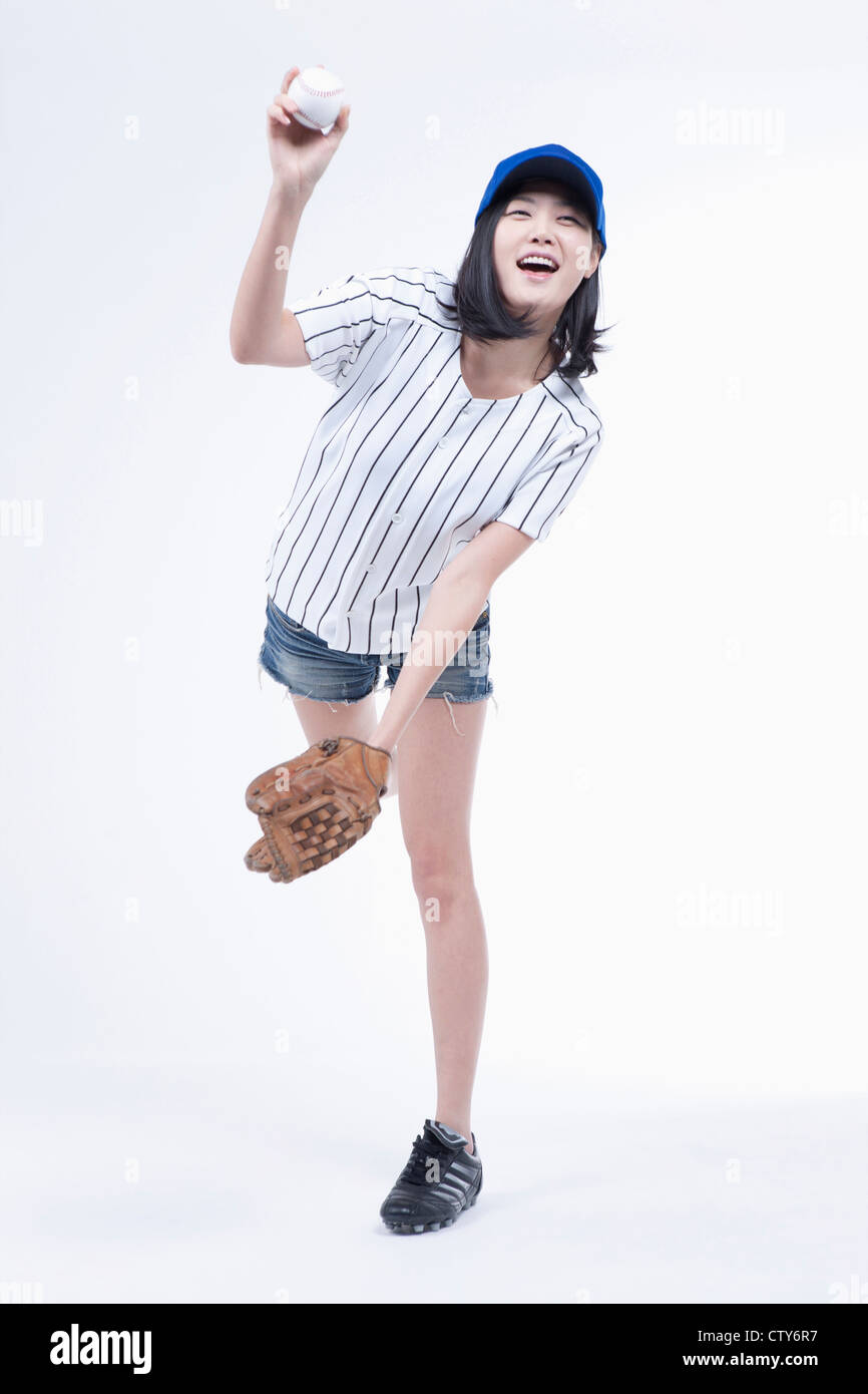 A female baseball player pitching a ball Stock Photo Alamy