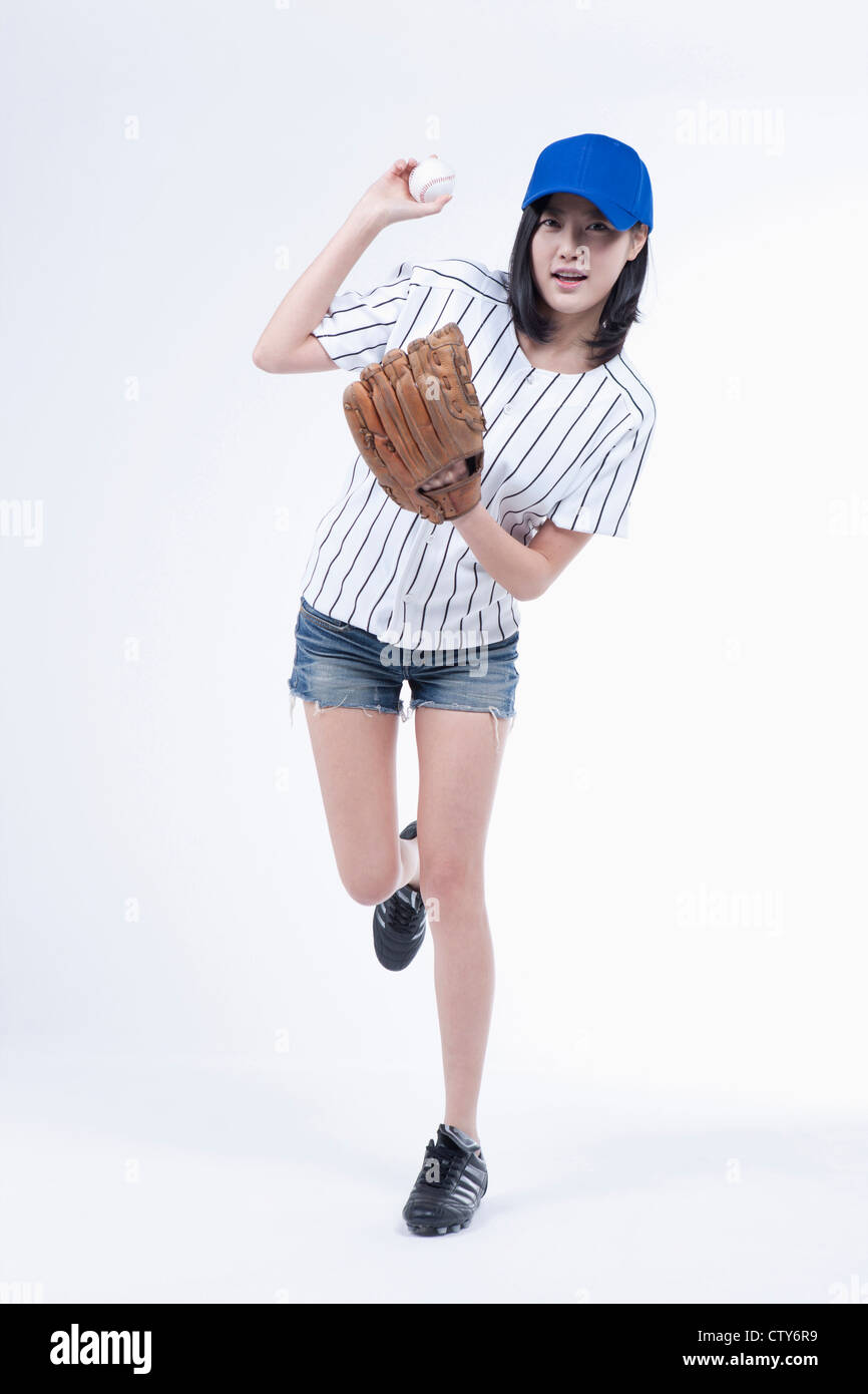 A female baseball player pitching a ball Stock Photo Alamy