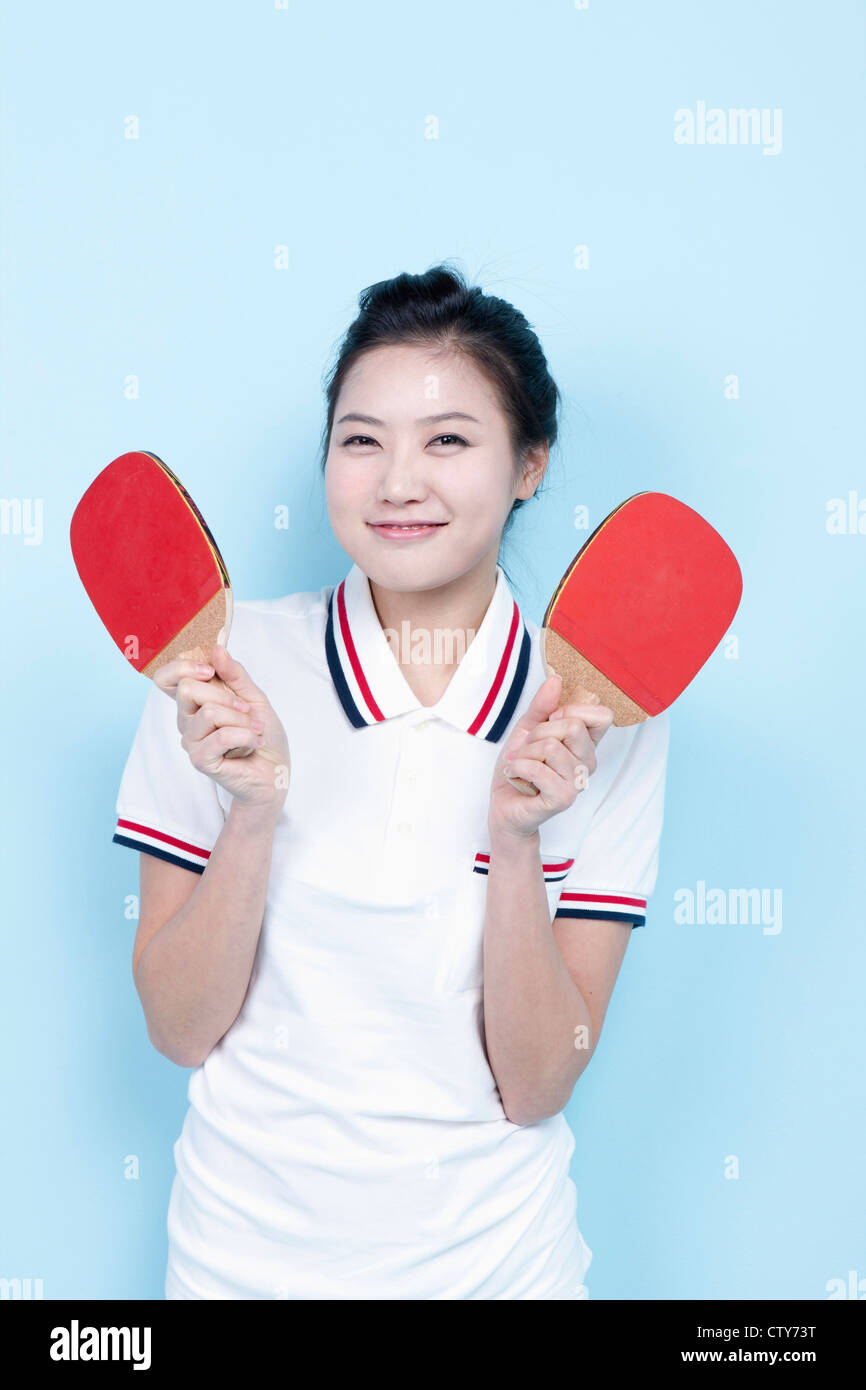A female ping-pong player with rackets Stock Photo