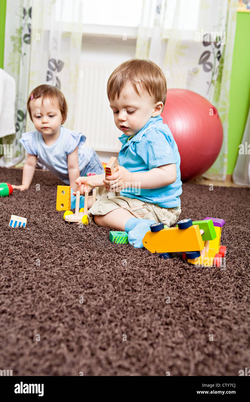 little toddler twins playing in the child's room Stock Photo
