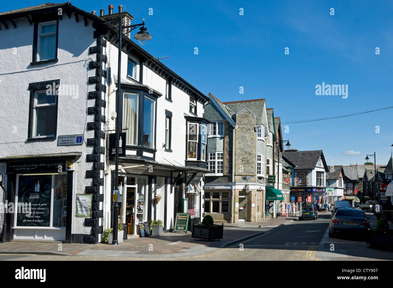 Shops businesses stores in the town centre in summer street view scene Crescent Road Windermere Cumbria England UK United Kingdom GB Great Britain Stock Photo