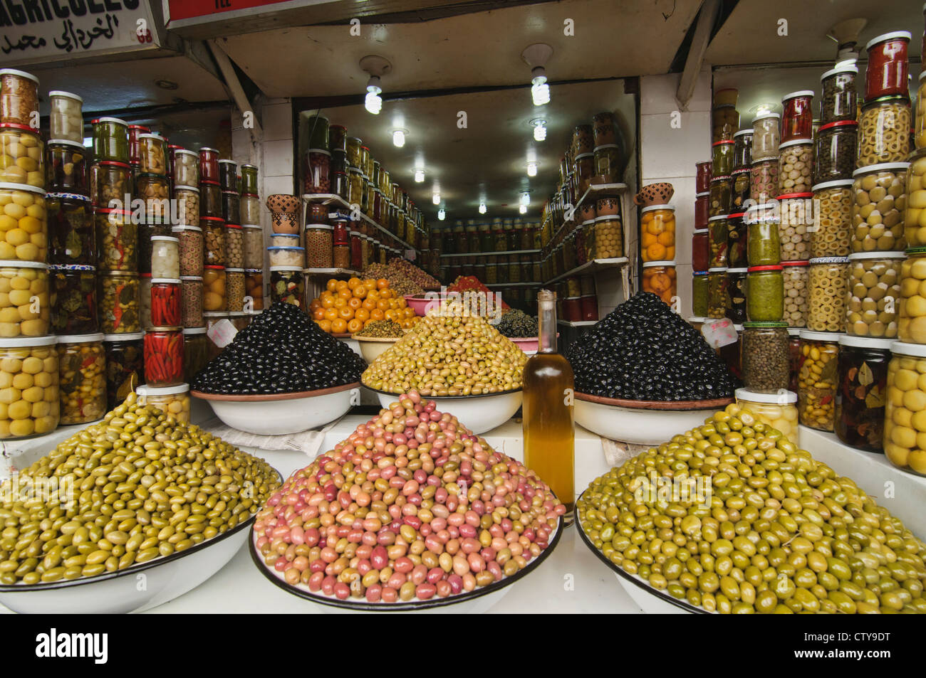 olive vendor in the ancient medina in Marrakech, Morocco Stock Photo