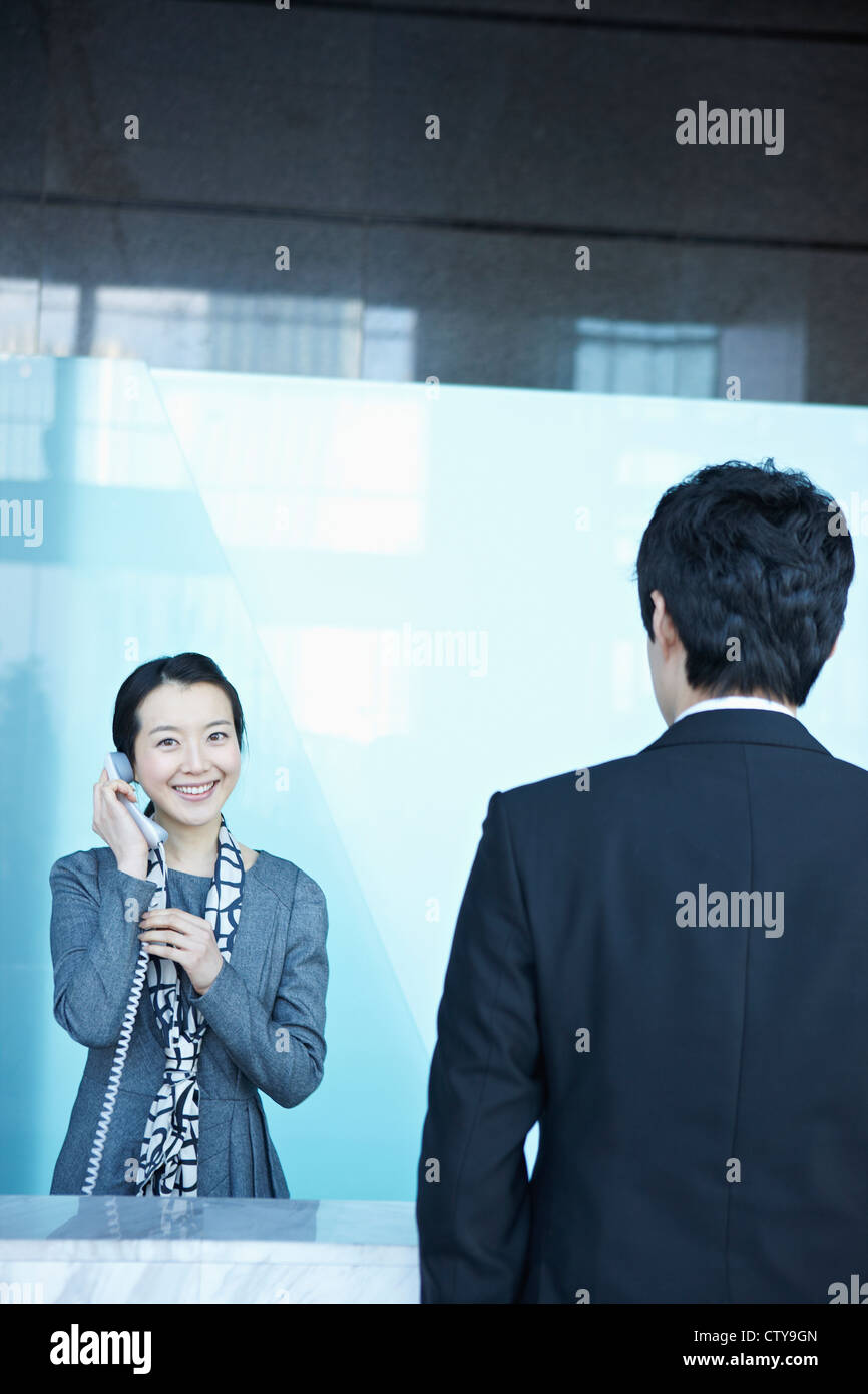 Reception Calling Phone A receptionist connecting a call Stock Photo - Alamy
