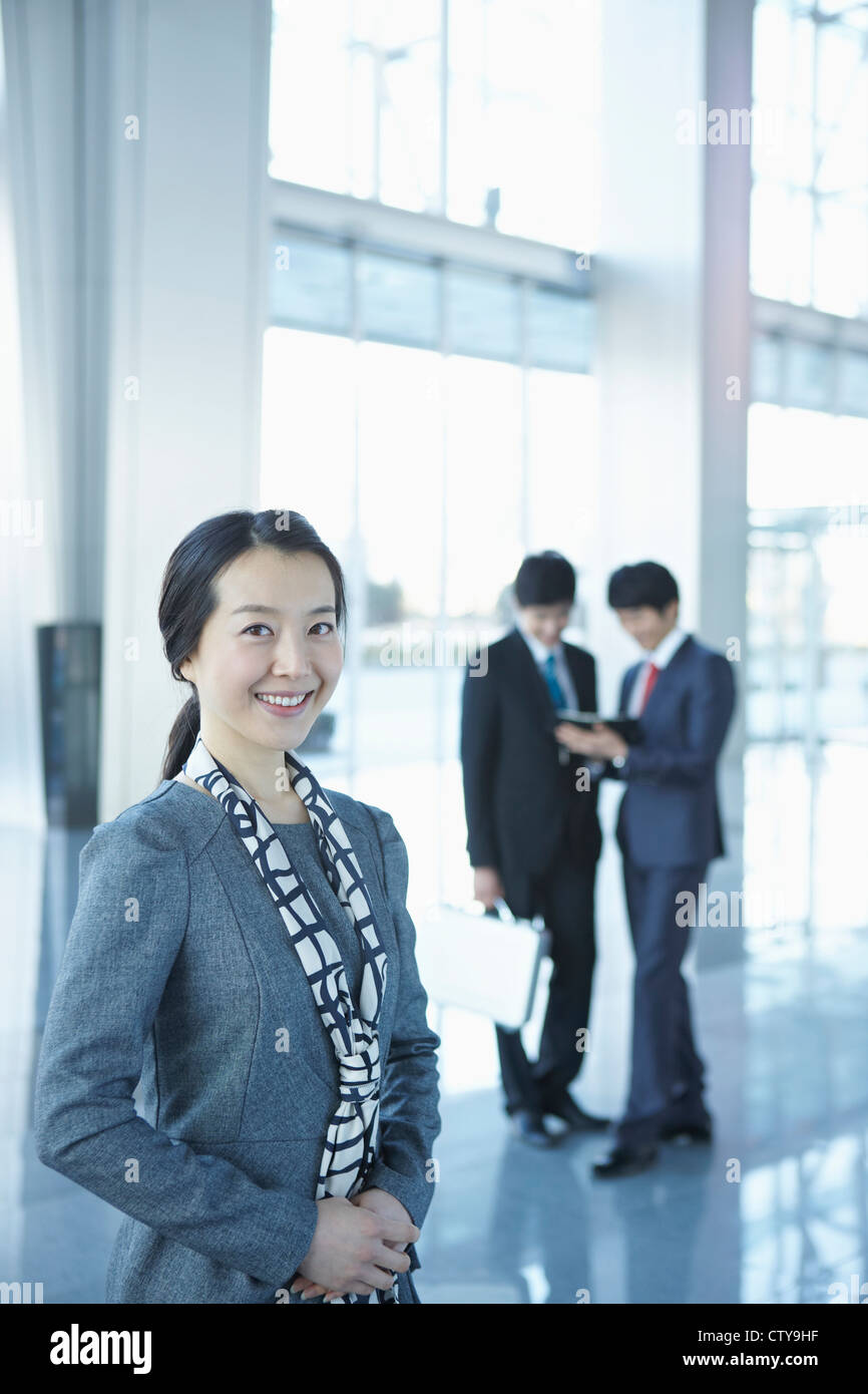 Businessmen standing in the lobby Stock Photo - Alamy