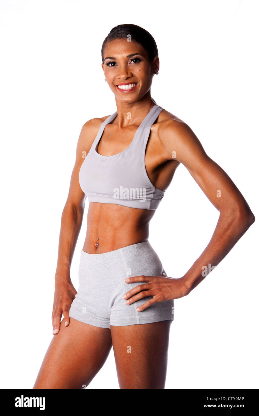 Beautiful toned muscular fitness body of happy smiling African female  athlete in grey, isolated Stock Photo - Alamy