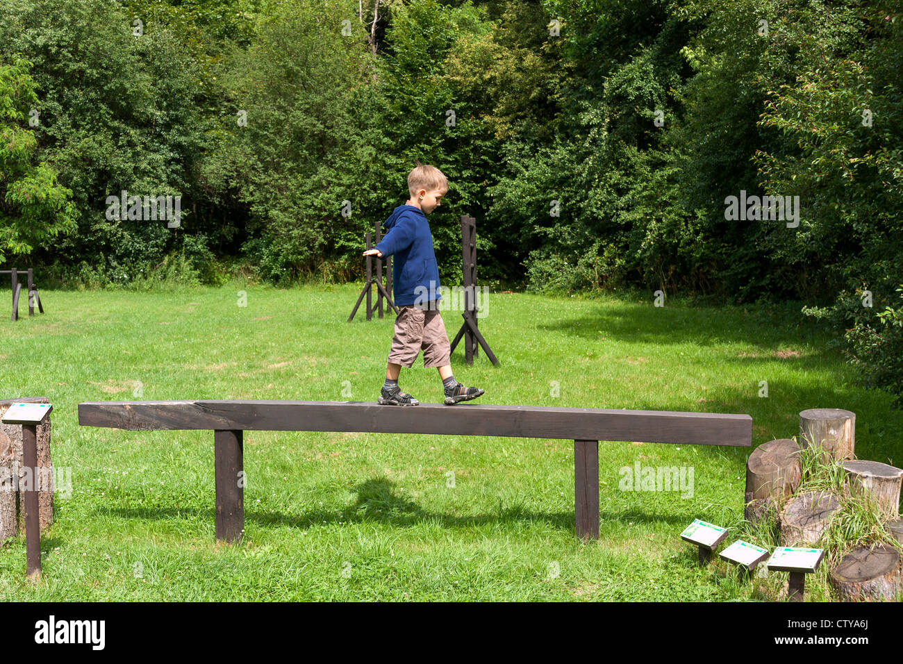 Boy practising on balance beam Stock Photo Alamy