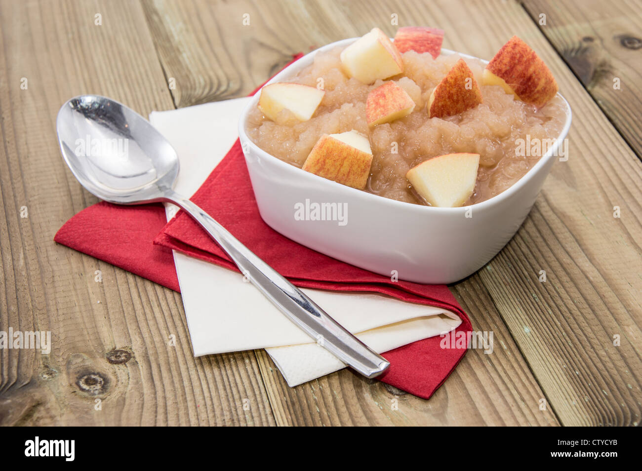 Applesauce with spoon on wooden background Stock Photo Alamy