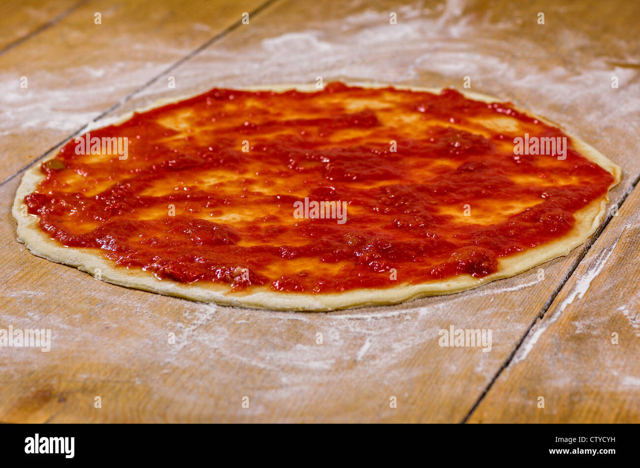 pizza dough with tomato sauce Stock Photo