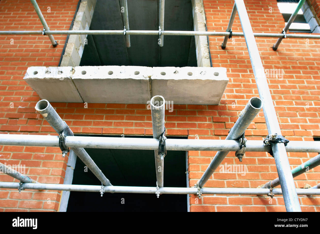 Scaffolding on brick wall Stock Photo - Alamy