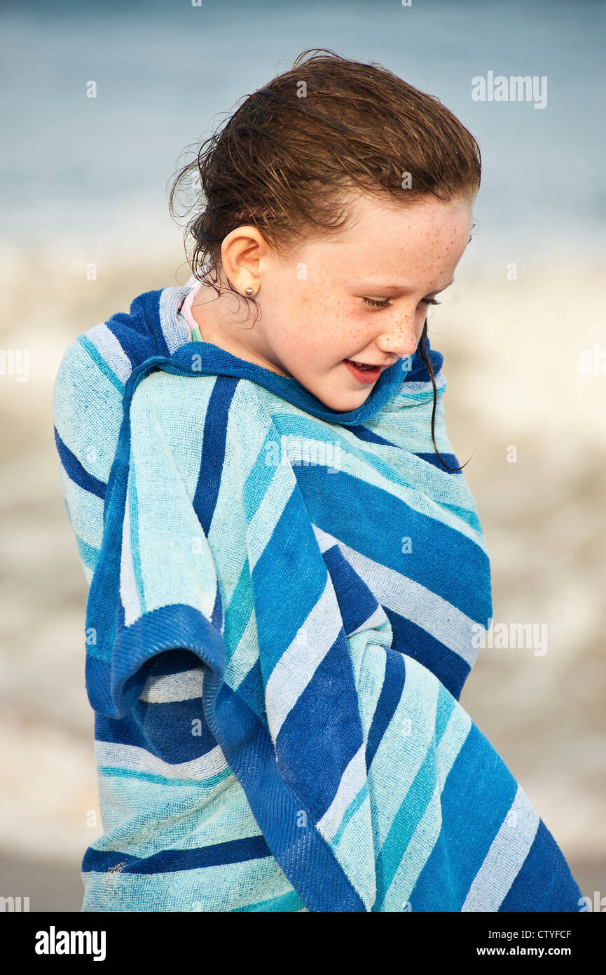 Cute young girl drying off with a beach towel, Cape Cod, MA Stock Photo