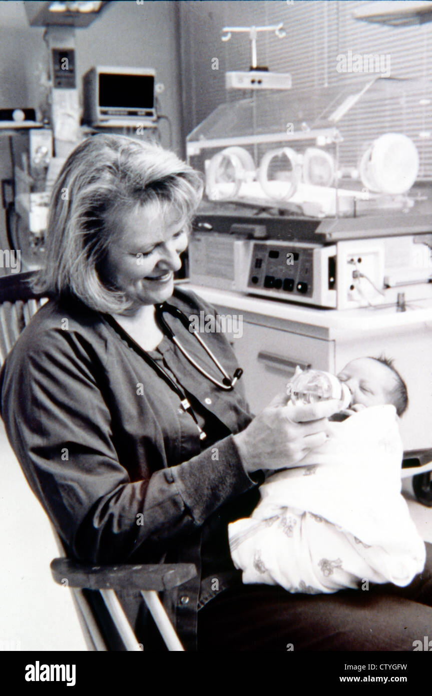 Nurse holding baby hi-res stock photography and images - Alamy