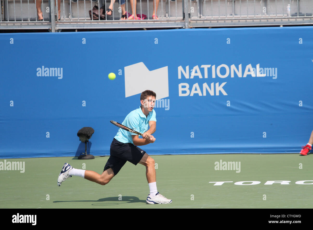 young tennis player return serve hard court Stock Photo